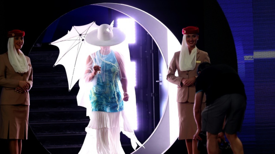 Osaka emerges for Melbourne opener under hat, veil and parasol